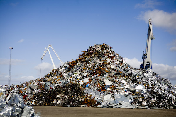 heap-of-metal-scrap-at-junkyard-against-blue-sky-2021-08-28-23-56-39-utc heap-of-metal-scrap-at-junkyard-against-blue-sky-2021-08-28-23-56-39-utc